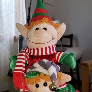 Santa carrying elf's deco